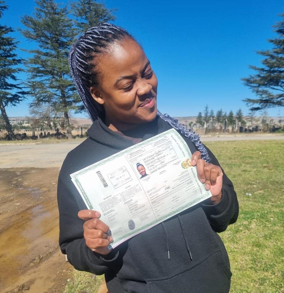 A Sir Kabs learner celebrating with her driving documents