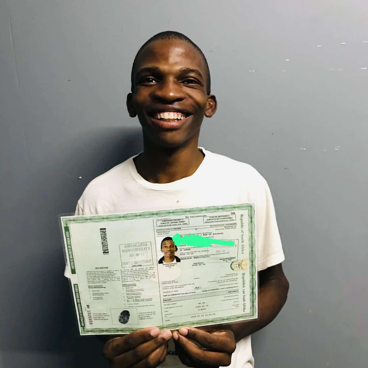 A Sir Kabs learner celebrating a successful driving milestone