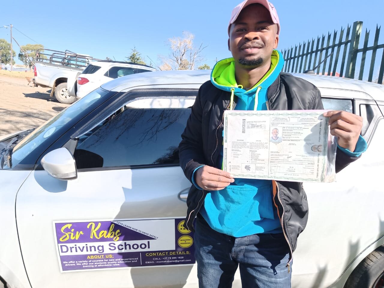 A Sir Kabs learner celebrating a successful driving milestone