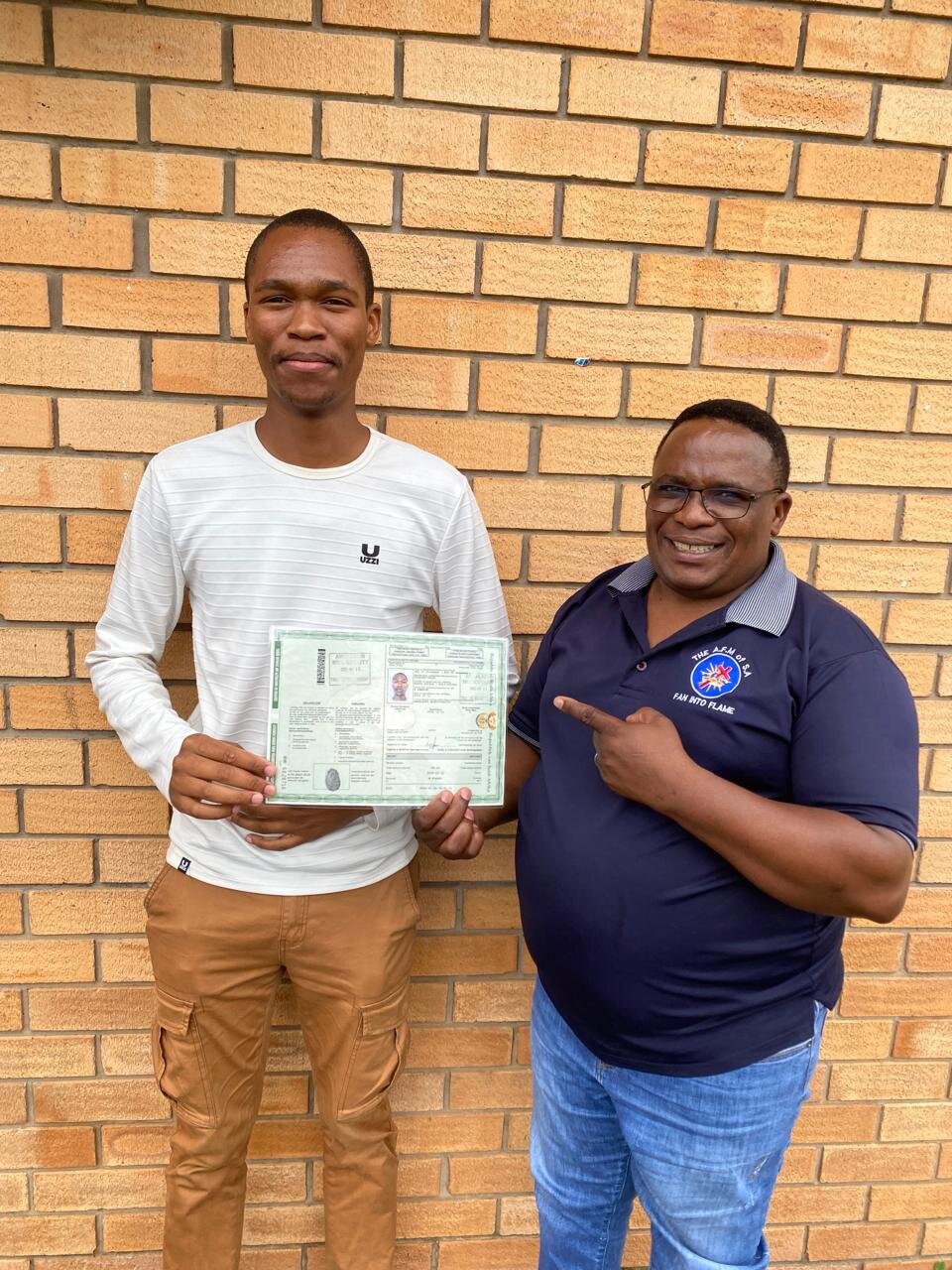 A Sir Kabs learner celebrating a successful driving milestone