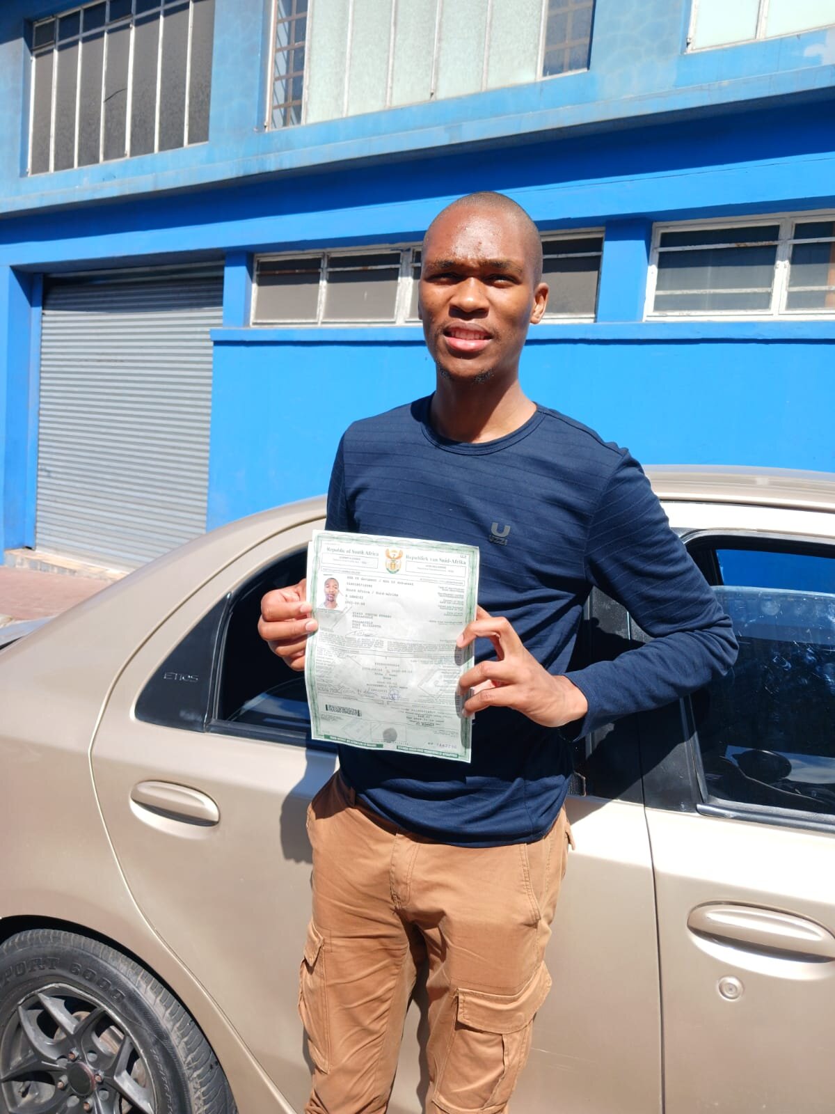 A Sir Kabs learner celebrating a successful driving milestone