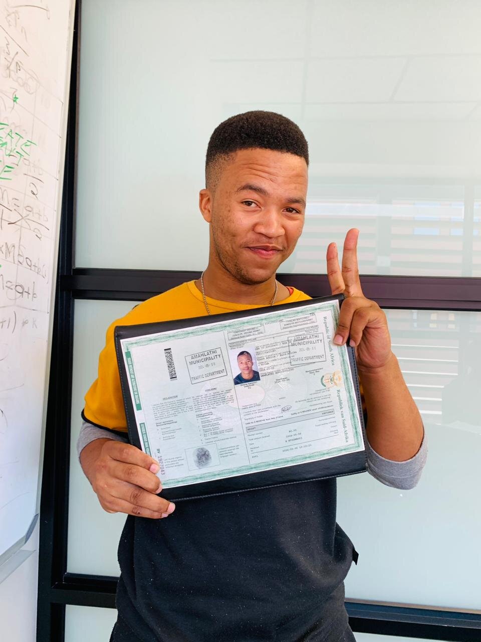 A Sir Kabs learner celebrating a successful driving milestone