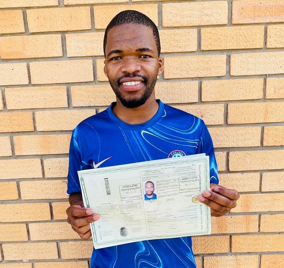 A Sir Kabs learner celebrating a successful driving milestone